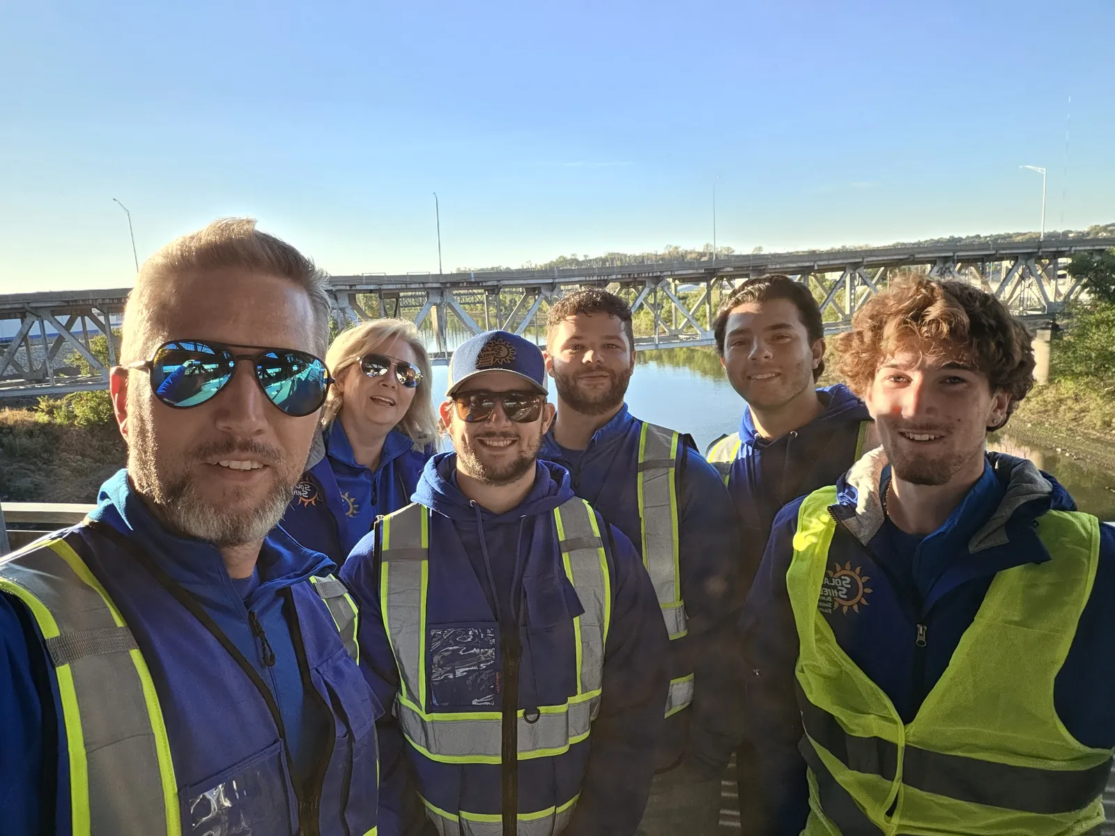 The crew in safety vests on a bridge job site
