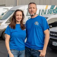 Denise and Tim Sanders in front of the Solar Shield Blinds fleet