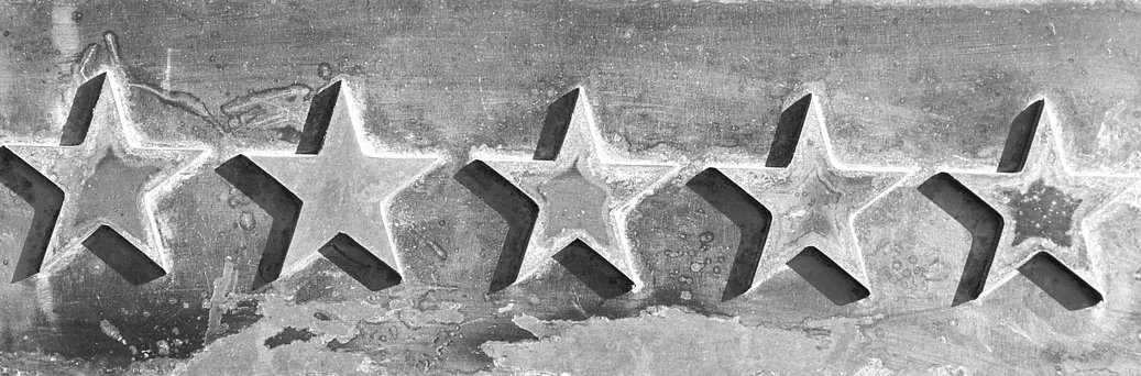 Five stars pressed into a gray concrete surface