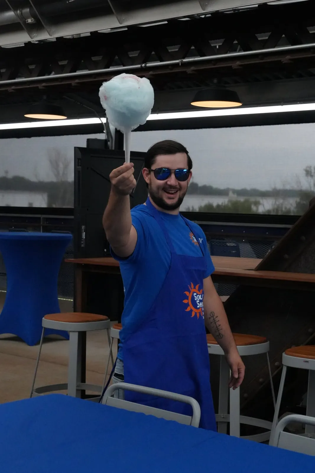A team member with cotton candy at a company event