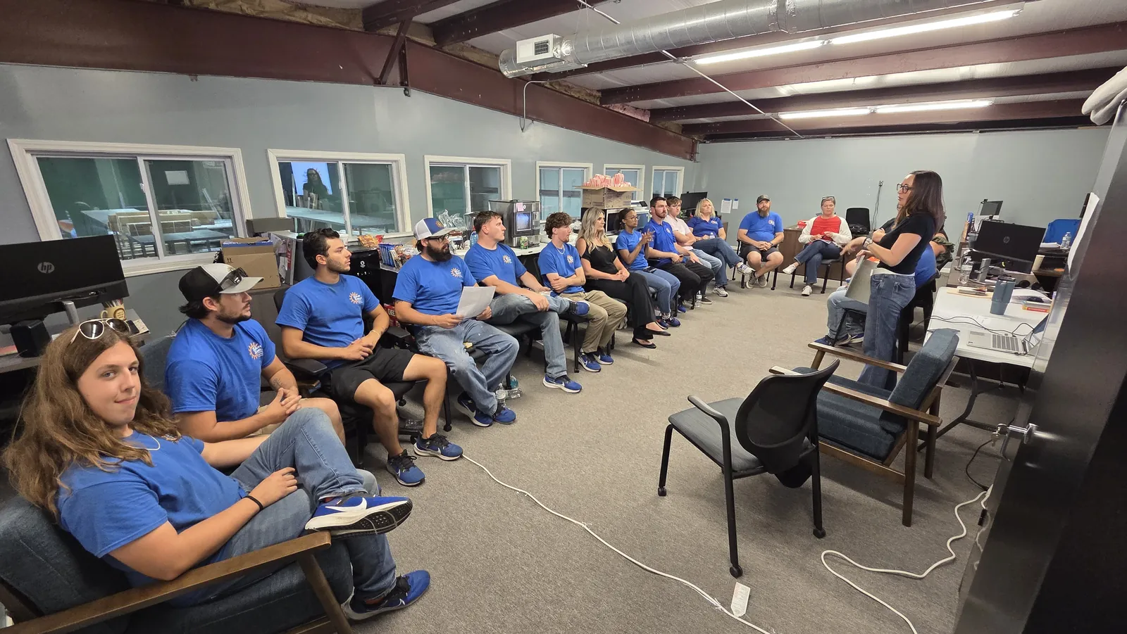 The whole team sitting in a circle for a meeting at the office
