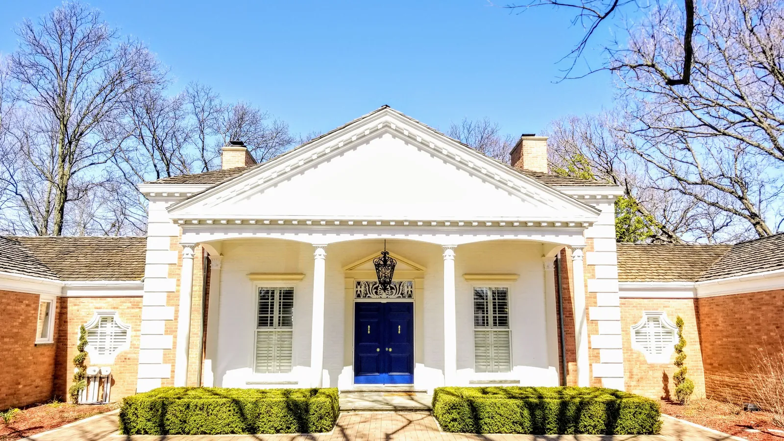 The front of Laura's home, with the cross pattern window beside the portico