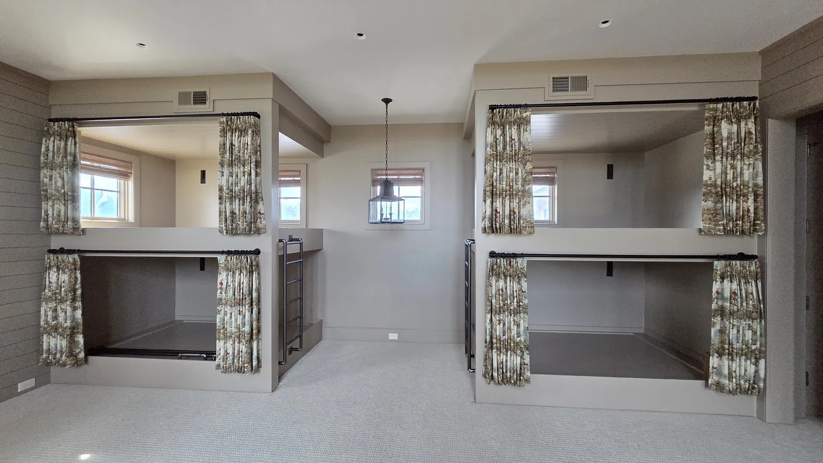 Patterned curtains that close off two sets of built in bunk beds, installed by Solar Shield Blinds