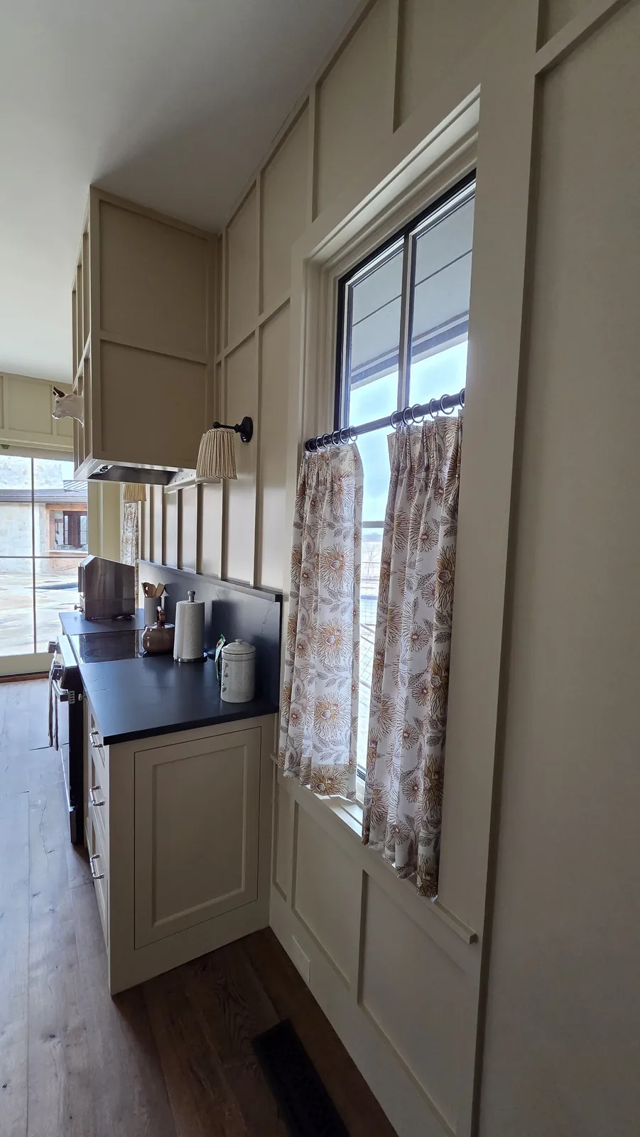 Café curtains on a kitchen window beside the counter, installed by Solar Shield Blinds