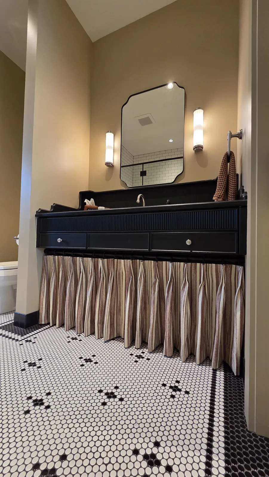 A gathered skirt curtain under a bathroom vanity on a hex tile floor, installed by Solar Shield Blinds