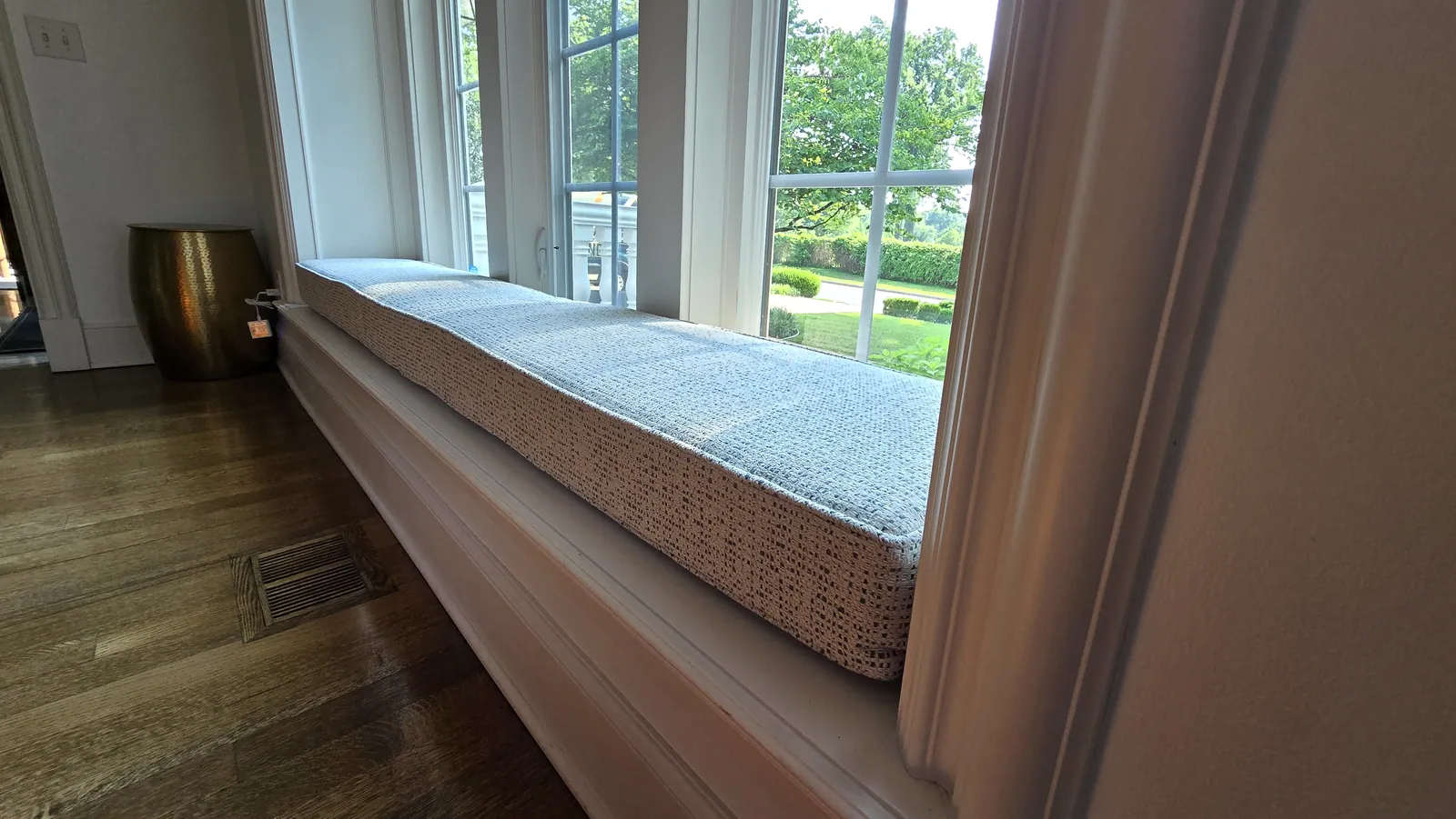 Custom cushion on a window seat, installed by Solar Shield Blinds