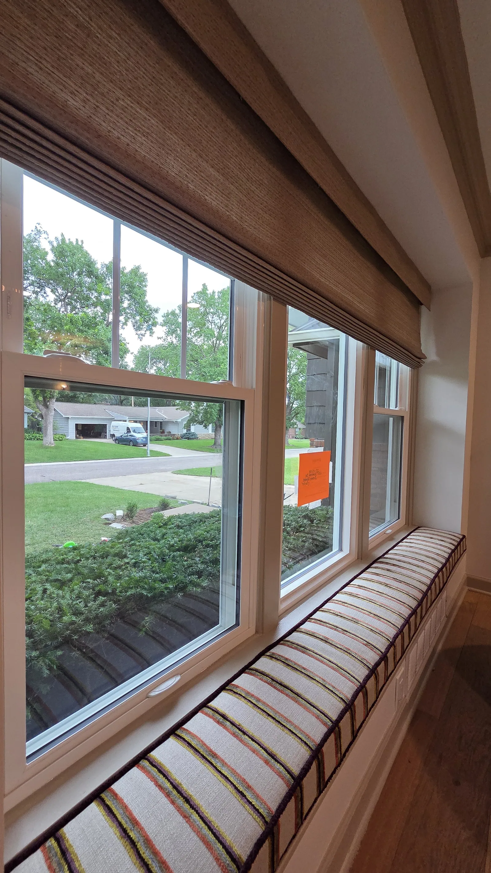 A long striped cushion on a window seat, installed by Solar Shield Blinds