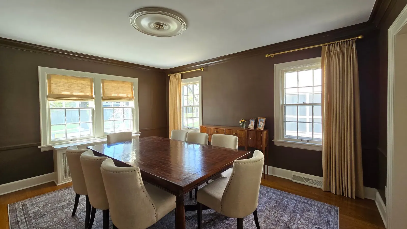 Custom drapery panels either side of a dining room window