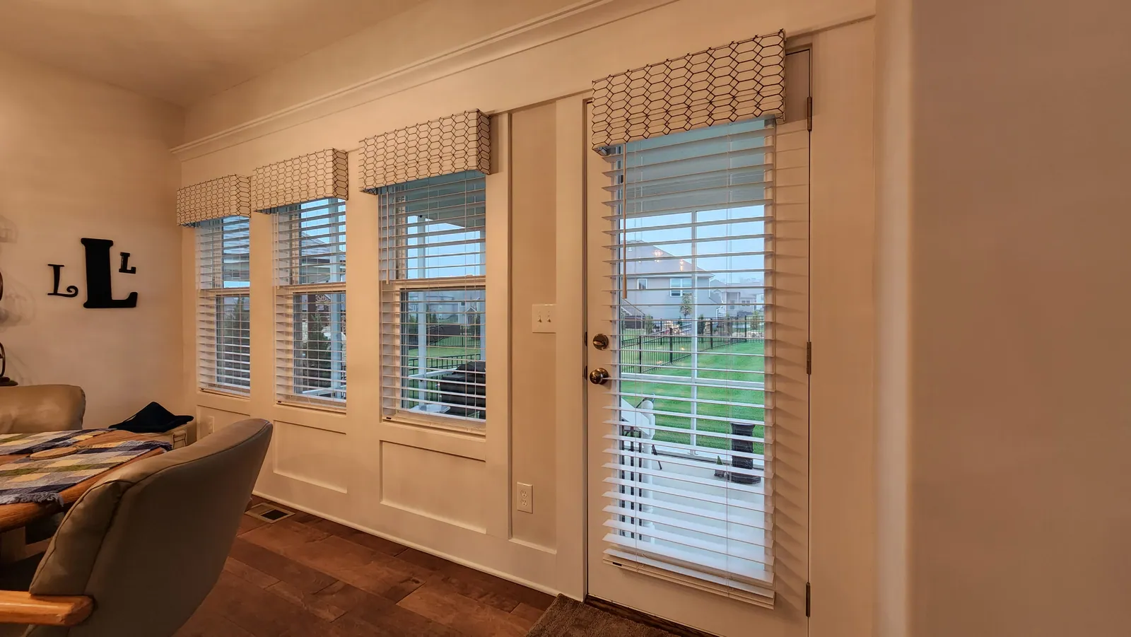 Cornices over a row of windows and a patio door, installed by Solar Shield Blinds