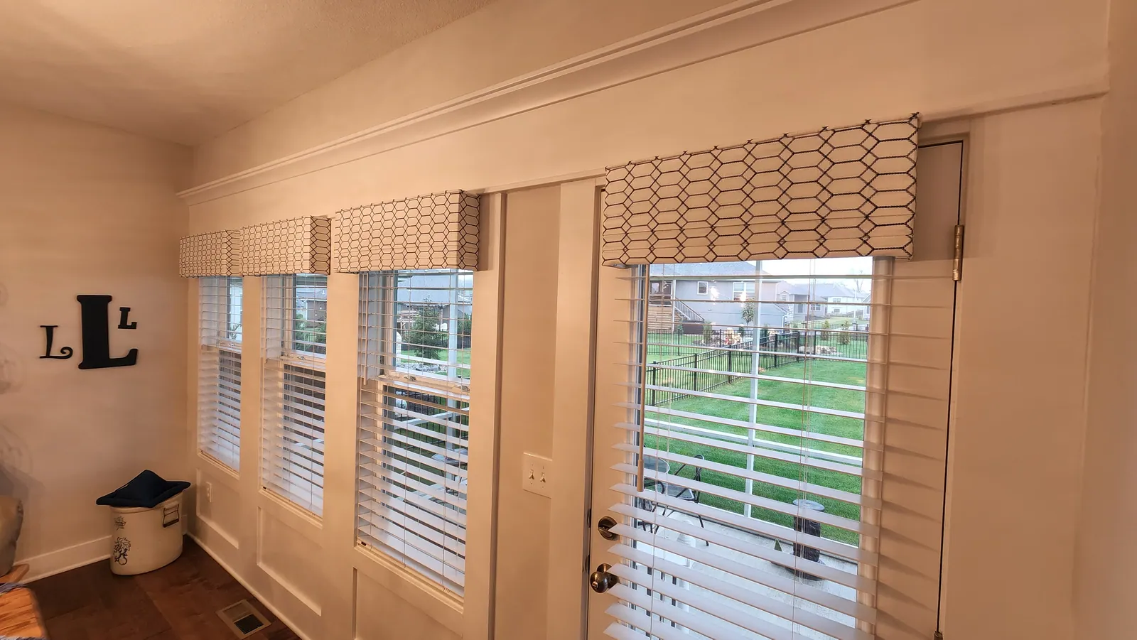 Cornices over windows and a door, installed by Solar Shield Blinds