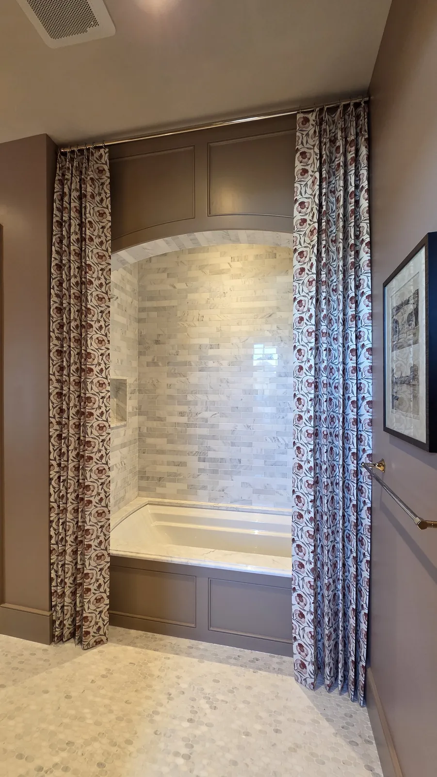 Patterned drapery panels framing a bathtub alcove, installed by Solar Shield Blinds