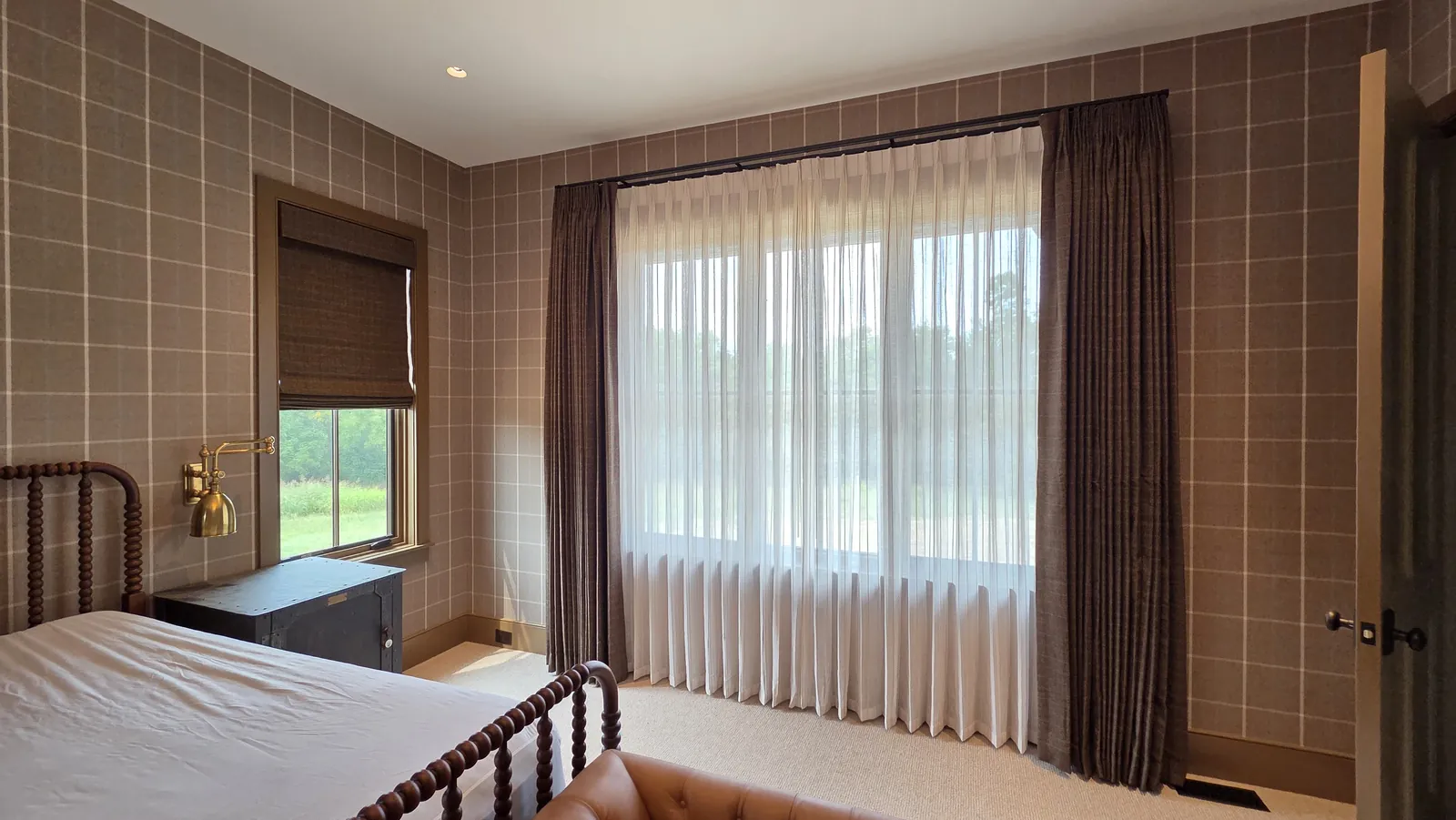 Sheer drapery with dark side panels over a wide bedroom window, installed by Solar Shield Blinds
