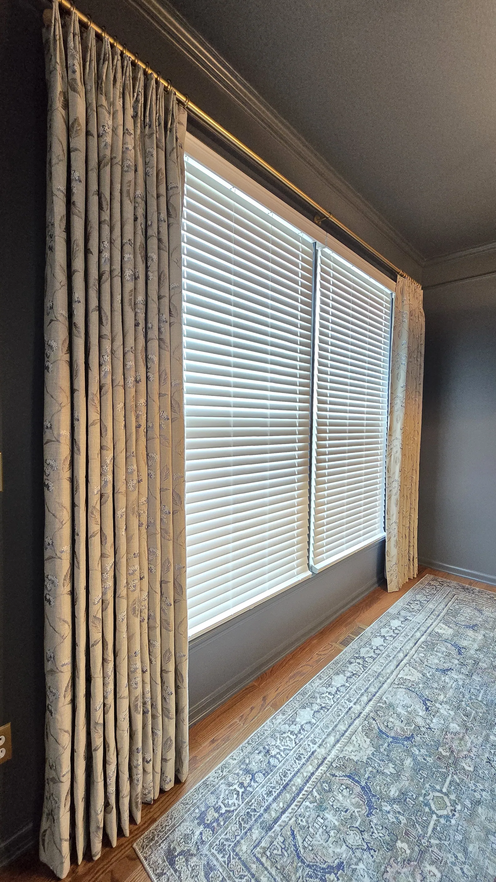 Full length drapery panel beside horizontal blinds, installed by Solar Shield Blinds