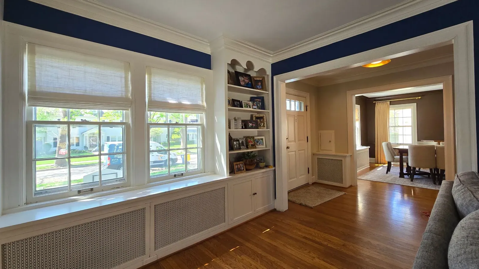 Roman shades on living room windows, installed by Solar Shield Blinds