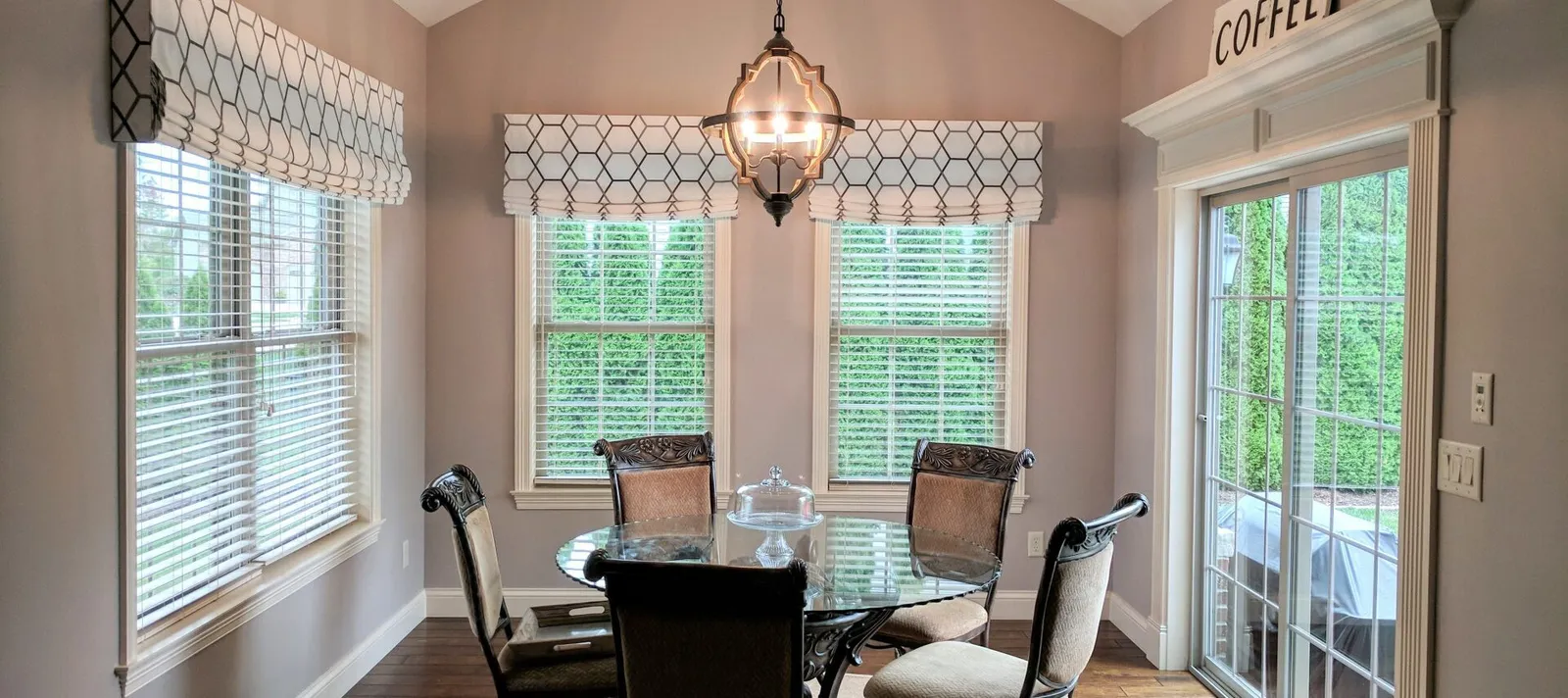 Patterned roman valances over blinds breakfast nook, installed by Solar Shield Blinds