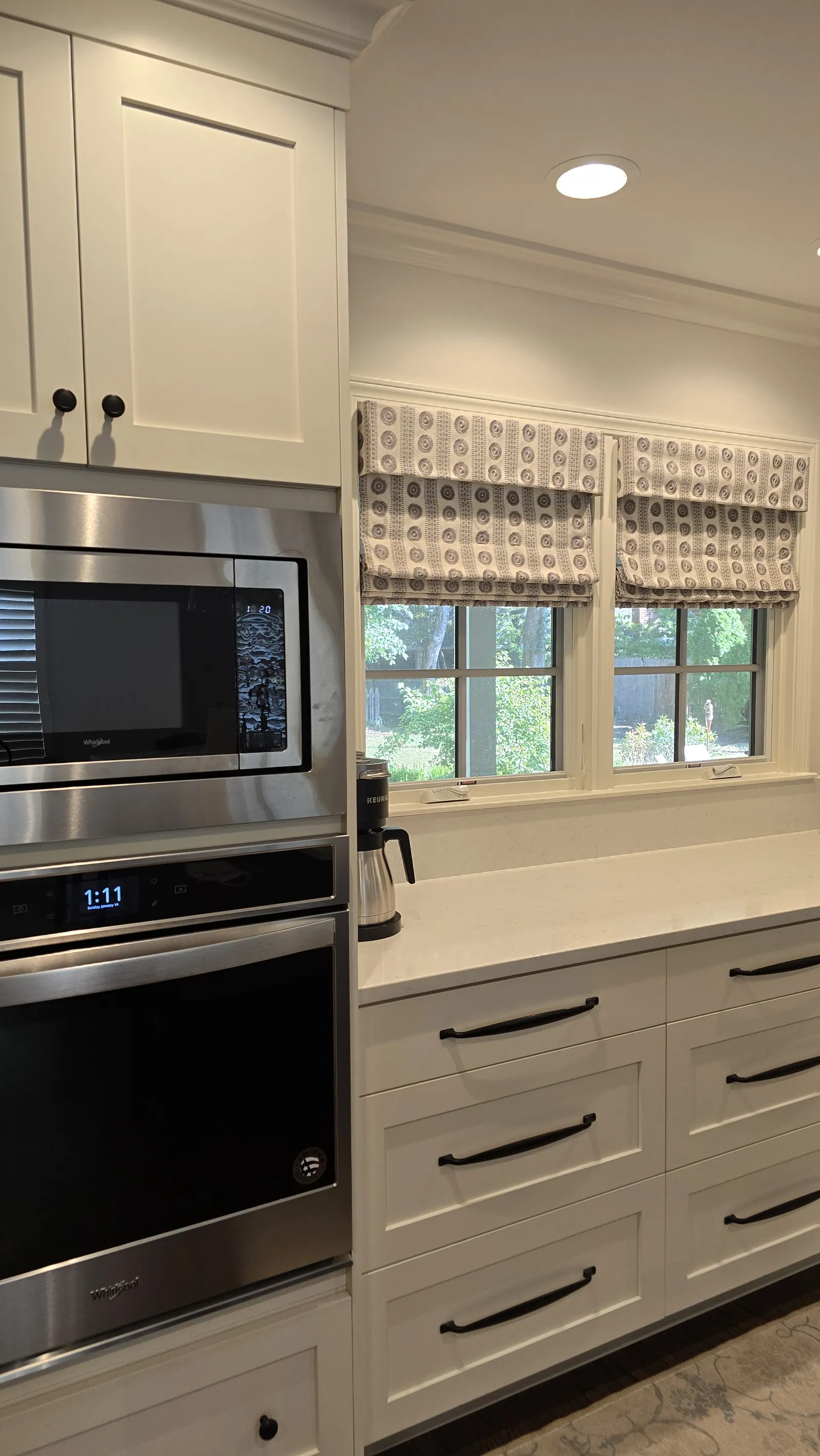 Roman shade above a kitchen counter, installed by Solar Shield Blinds