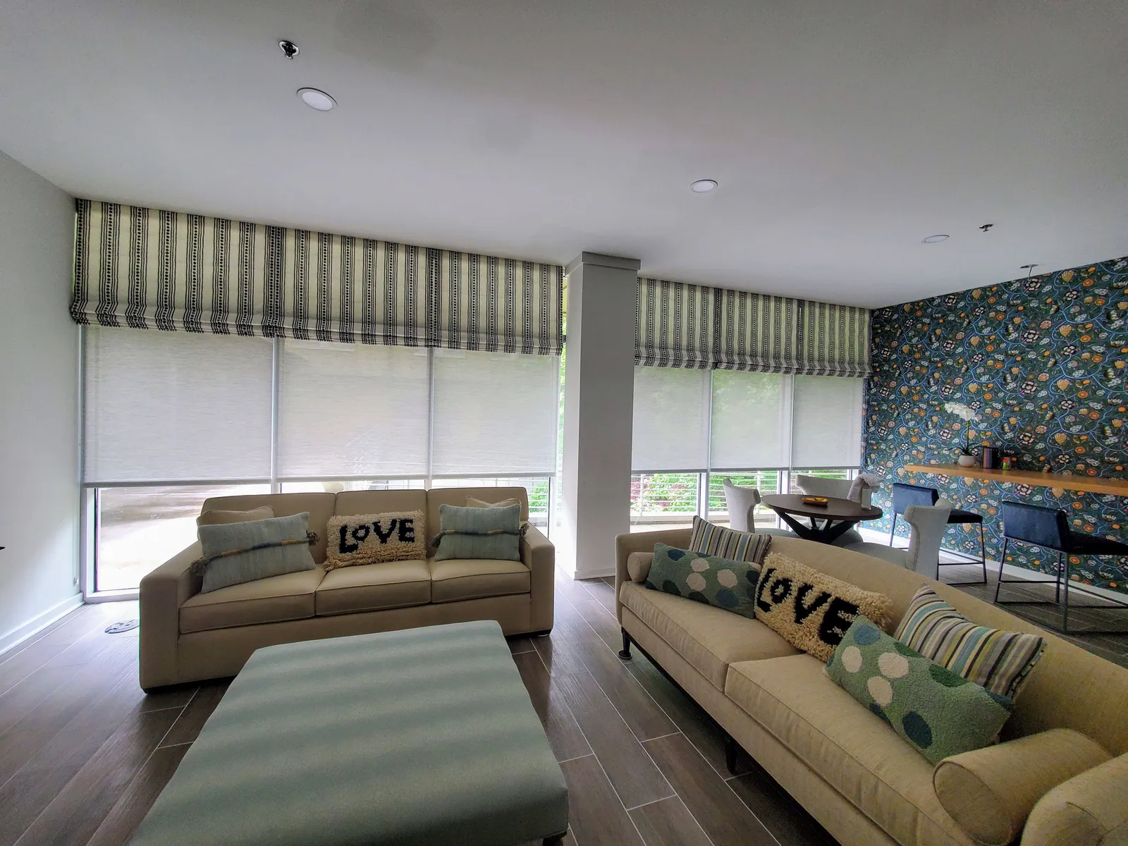 Custom Roman shades in a living room, installed by Solar Shield Blinds