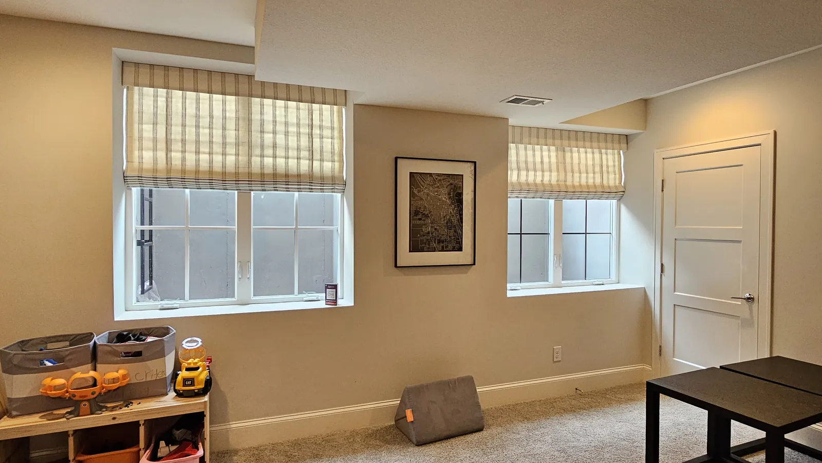 Roman shades in a playroom, installed by Solar Shield Blinds