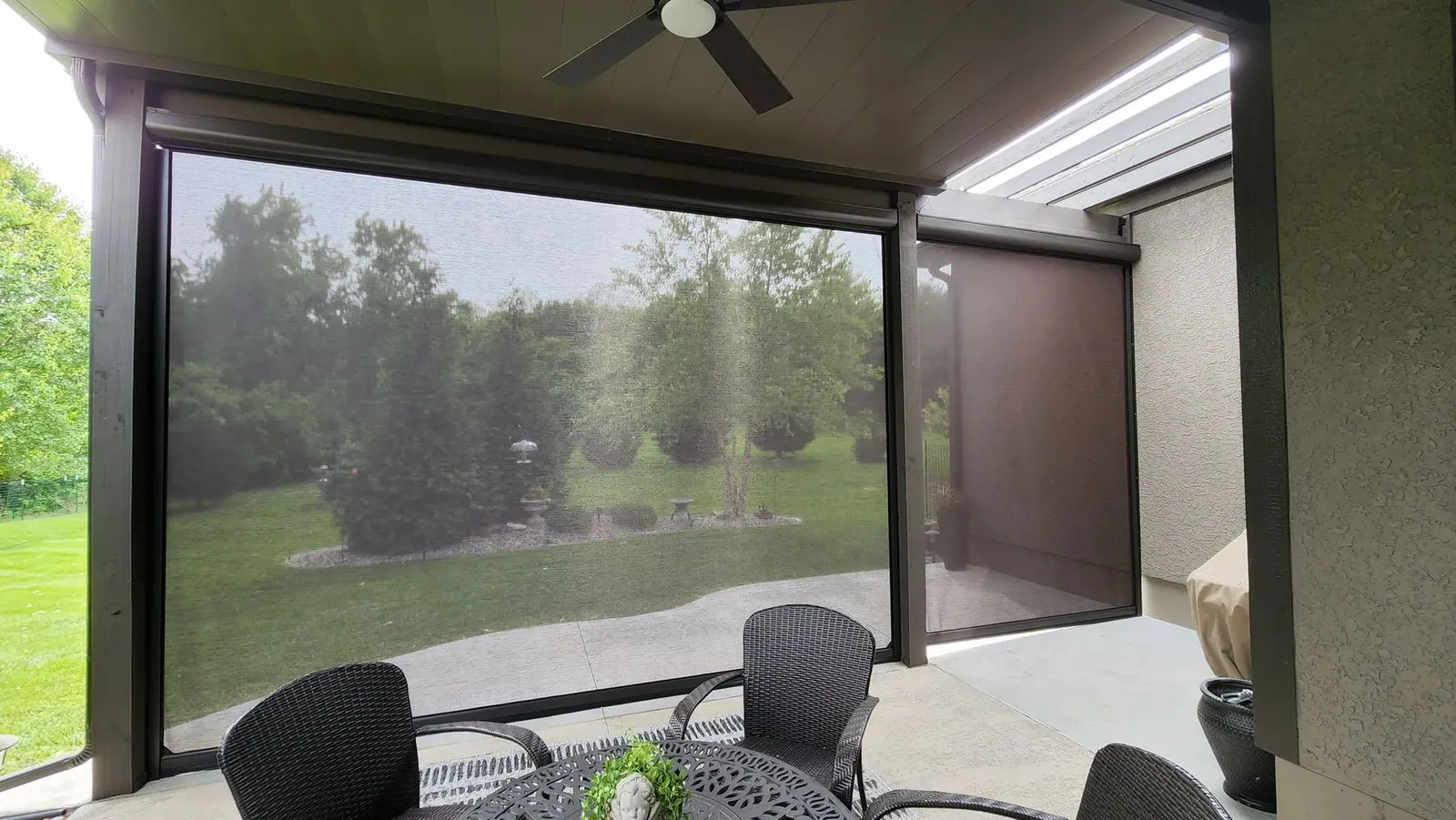 Exterior Patio Shades lower with screen door s, installed by Solar Shield Blinds