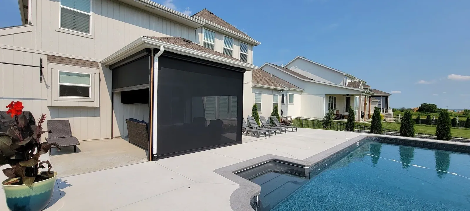 Exterior patio shades partly closed shades backyard pool, installed by Solar Shield Blinds