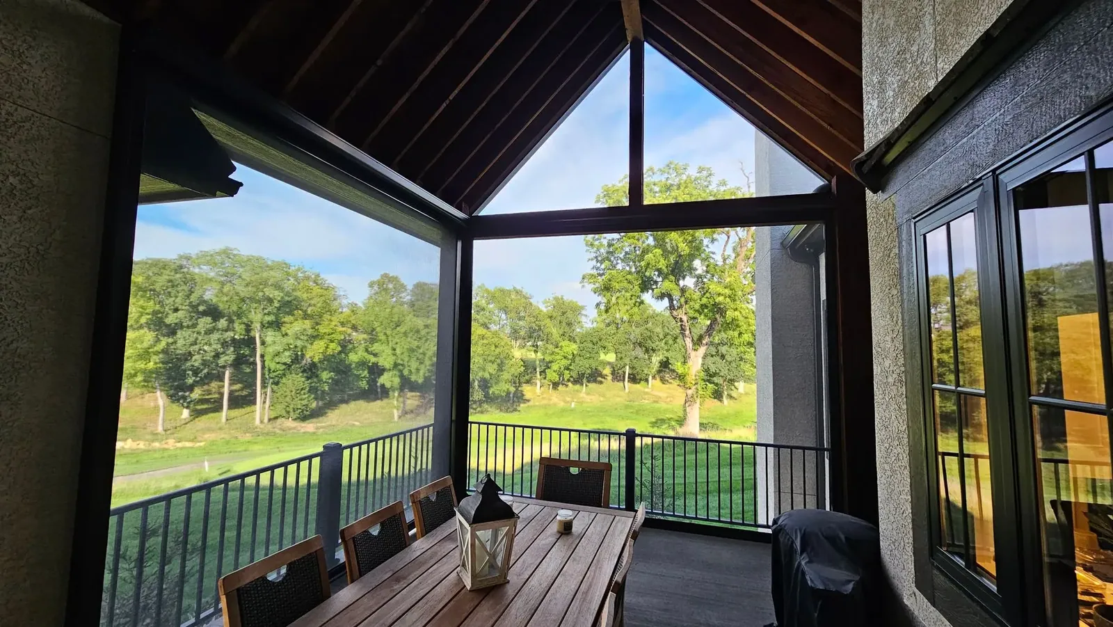 Exterior patio shades sunny green weather closed shades, installed by Solar Shield Blinds