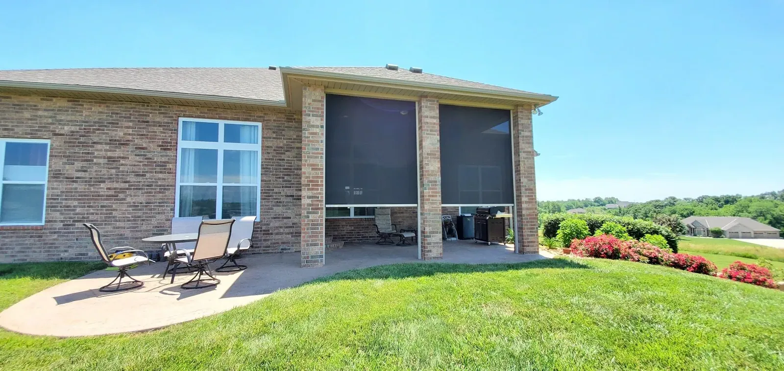 Half closed exterior patio shades motorized, installed by Solar Shield Blinds