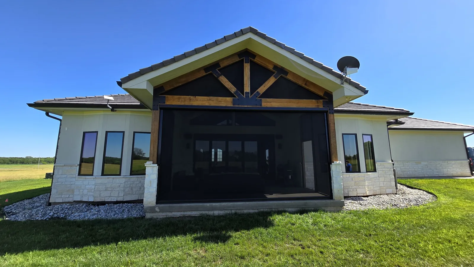 A home's covered gable porch screened in, with fixed screens across the triangle of the gable