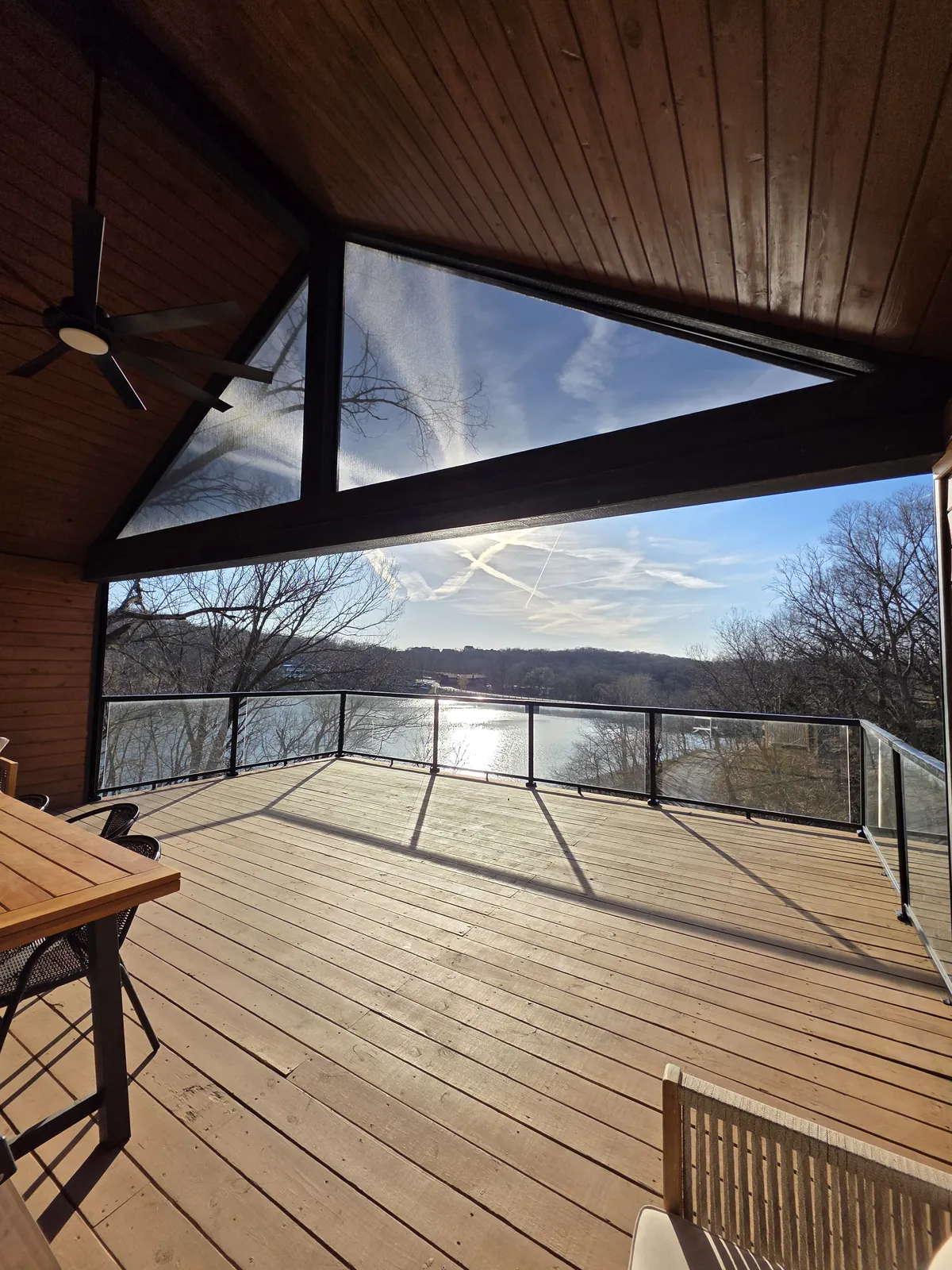 A fixed screen in the triangle of a gable over a deck