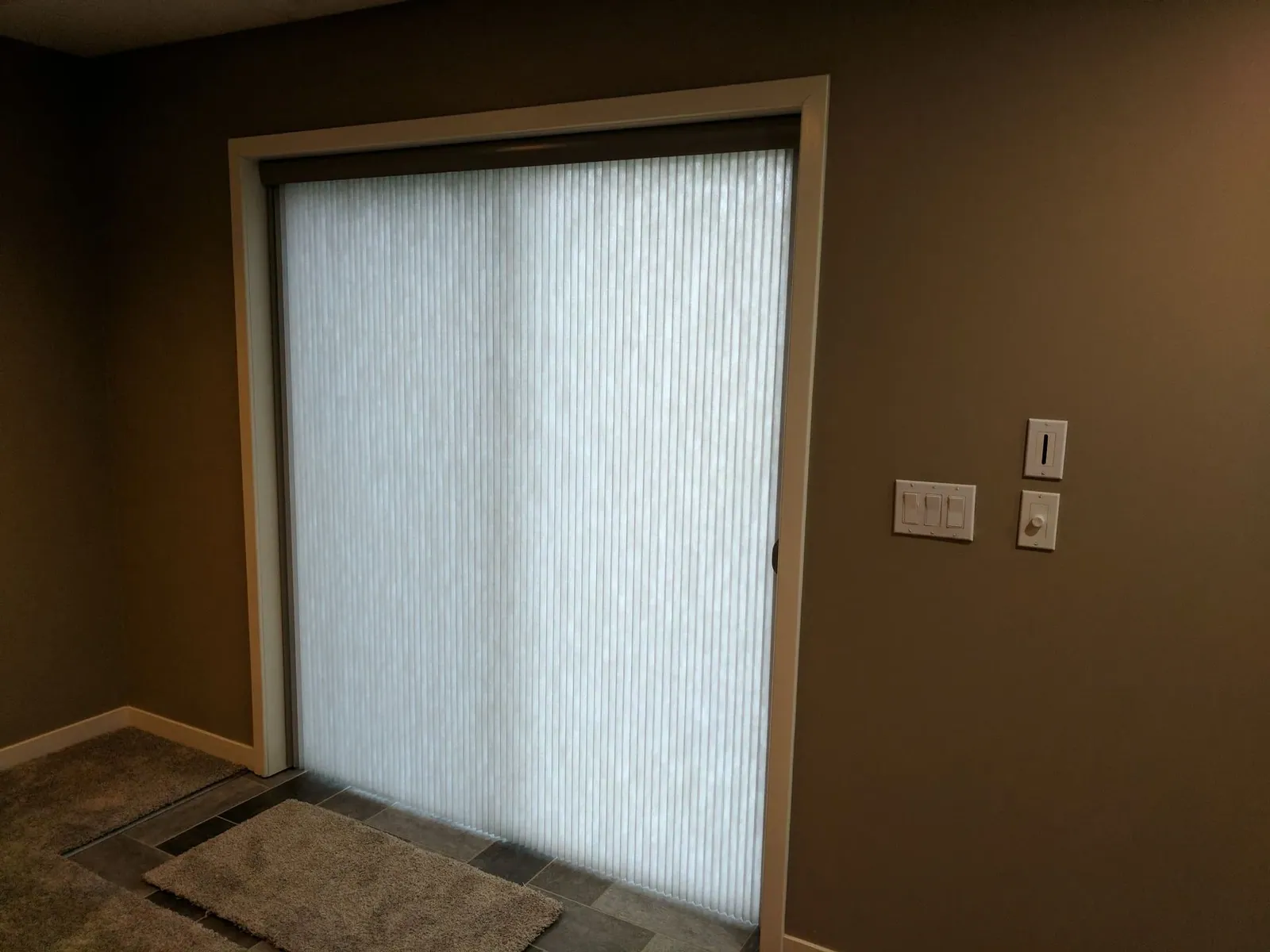 Closed vertical honeycomb shade on a family room sliding patio door, installed by Solar Shield Blinds