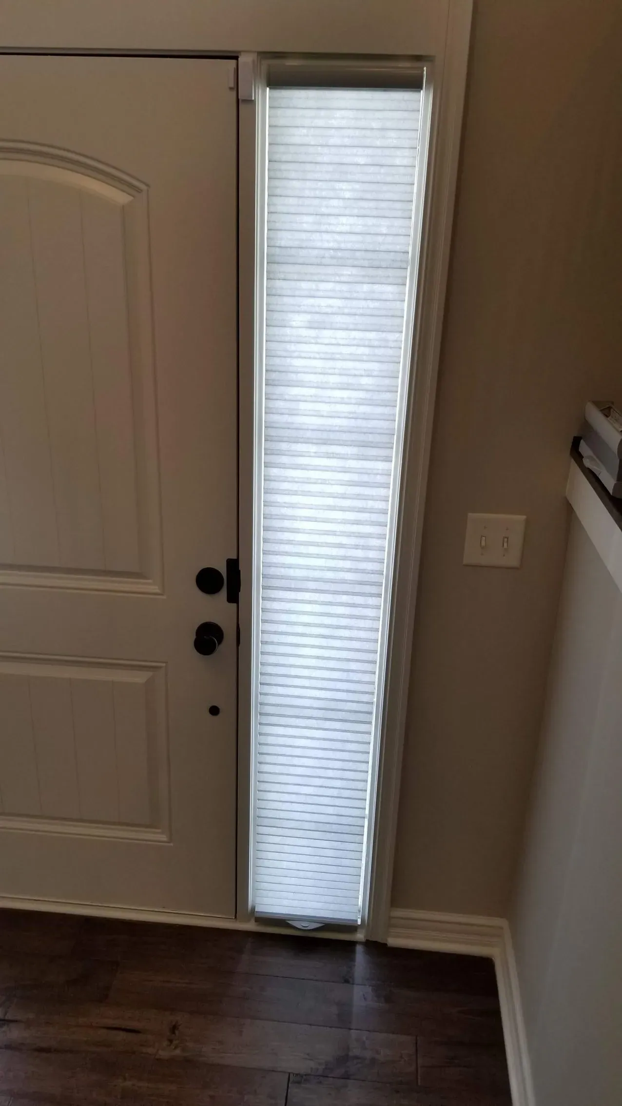 Custom honeycomb shades front door sidelight, installed by Solar Shield Blinds