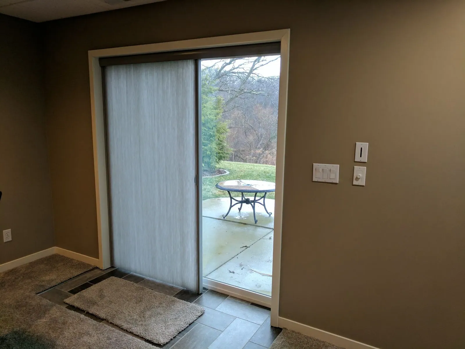 Custom honeycomb shades half open sliding glass door, installed by Solar Shield Blinds