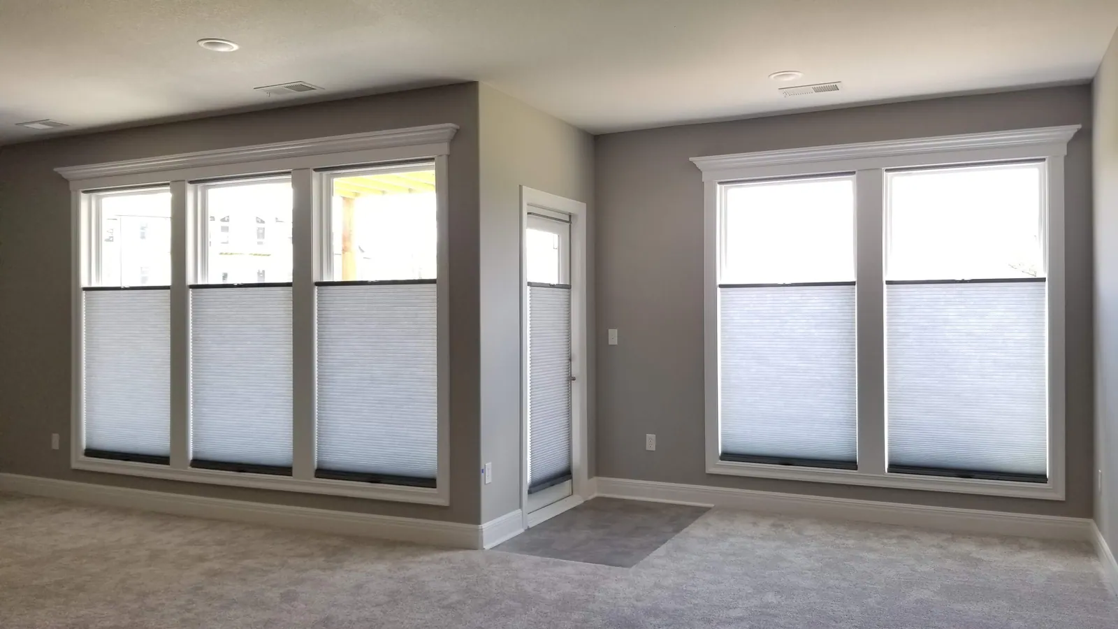 Cordless honeycomb shades installed in a family living room