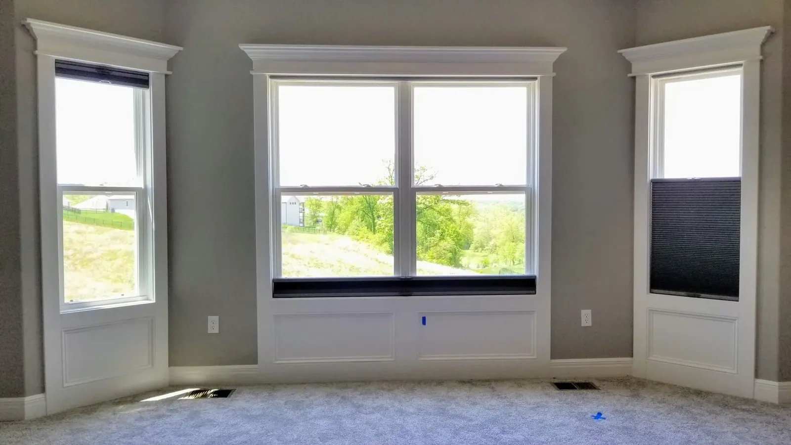 Honeycomb shades losed window in office, installed by Solar Shield Blinds