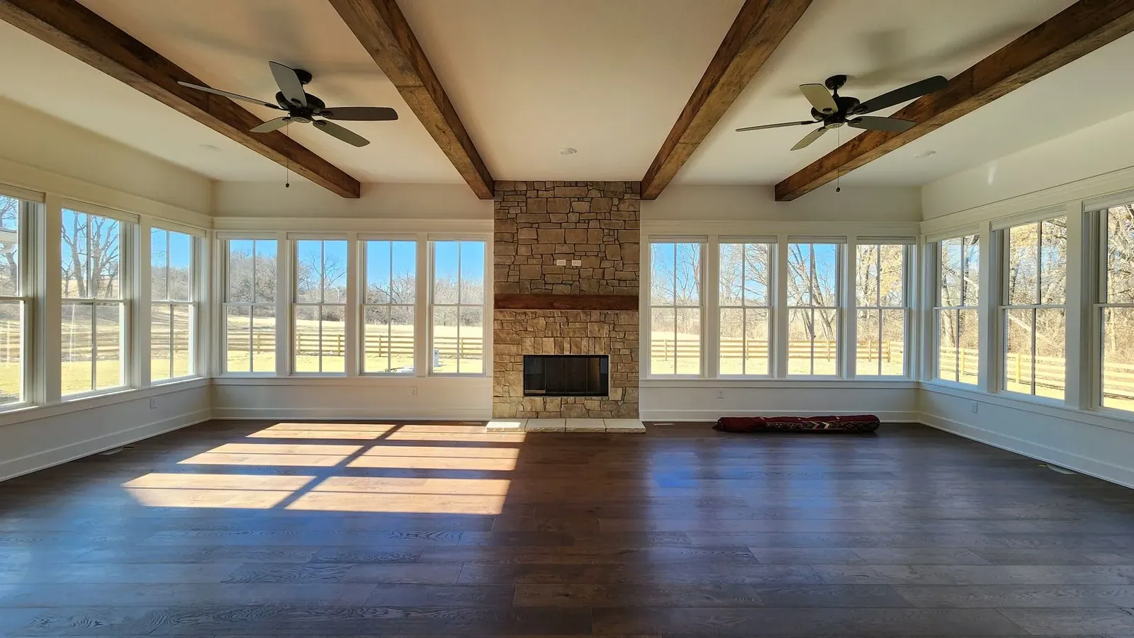 Honeycomb shades open living room with fireplace, installed by Solar Shield Blinds
