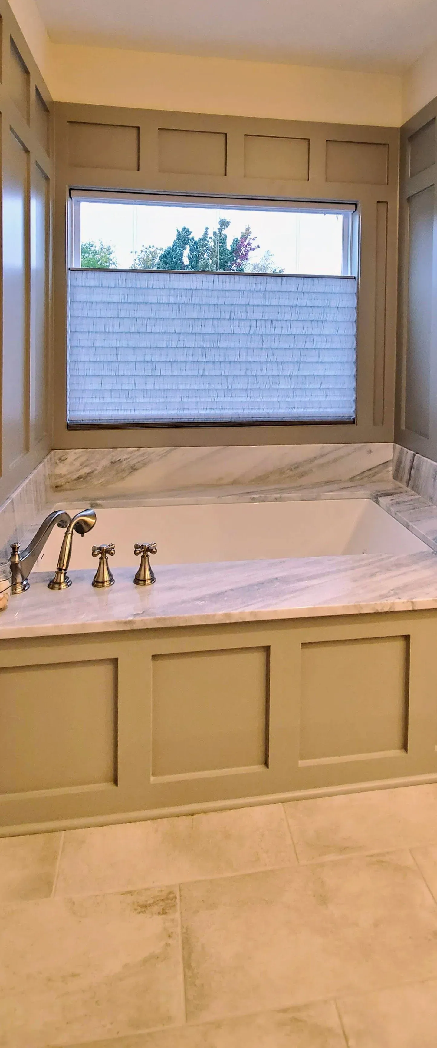 Top Down Bottom Up honeycomb shade above a bathtub, installed by Solar Shield Blinds