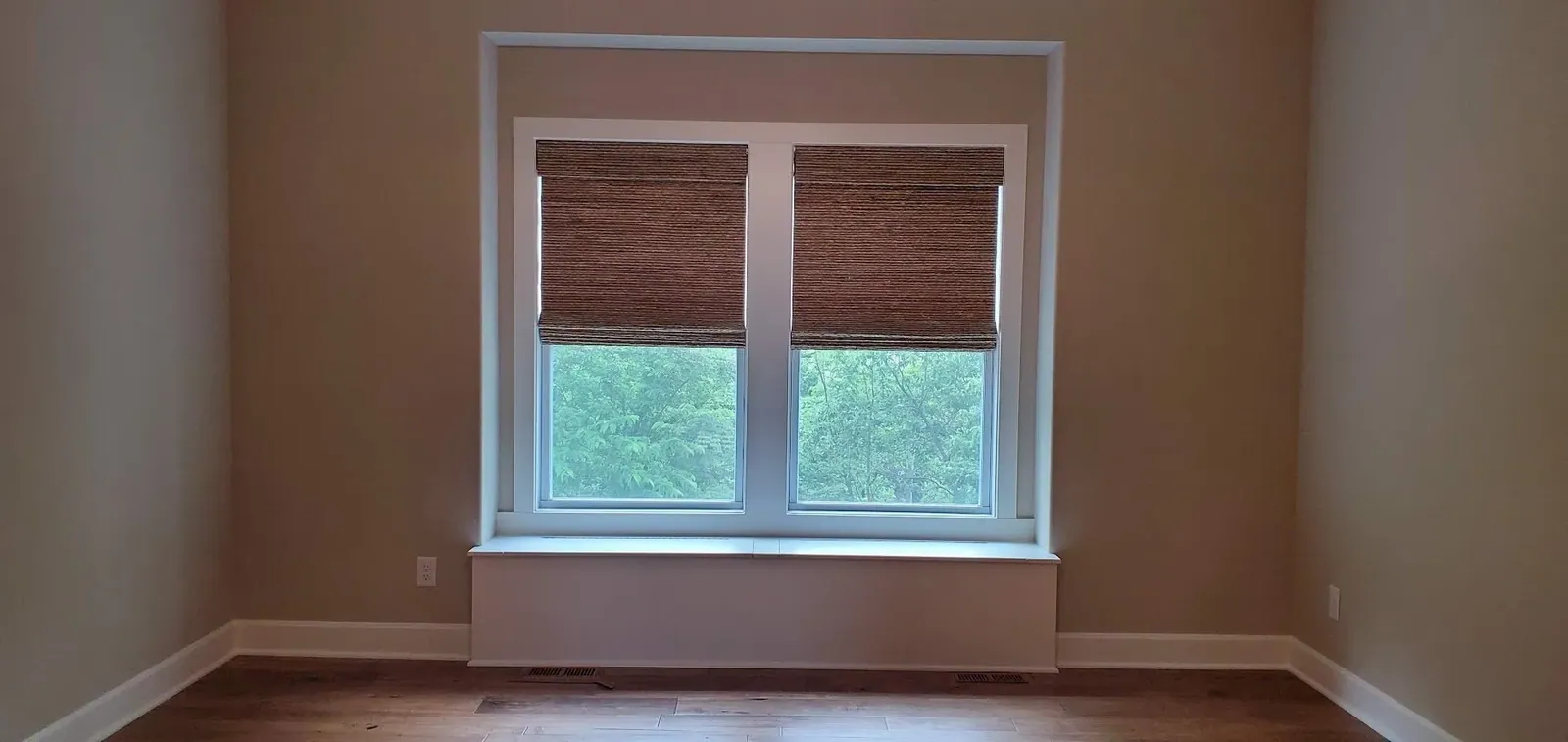 Natural woven shades filtering light across a window