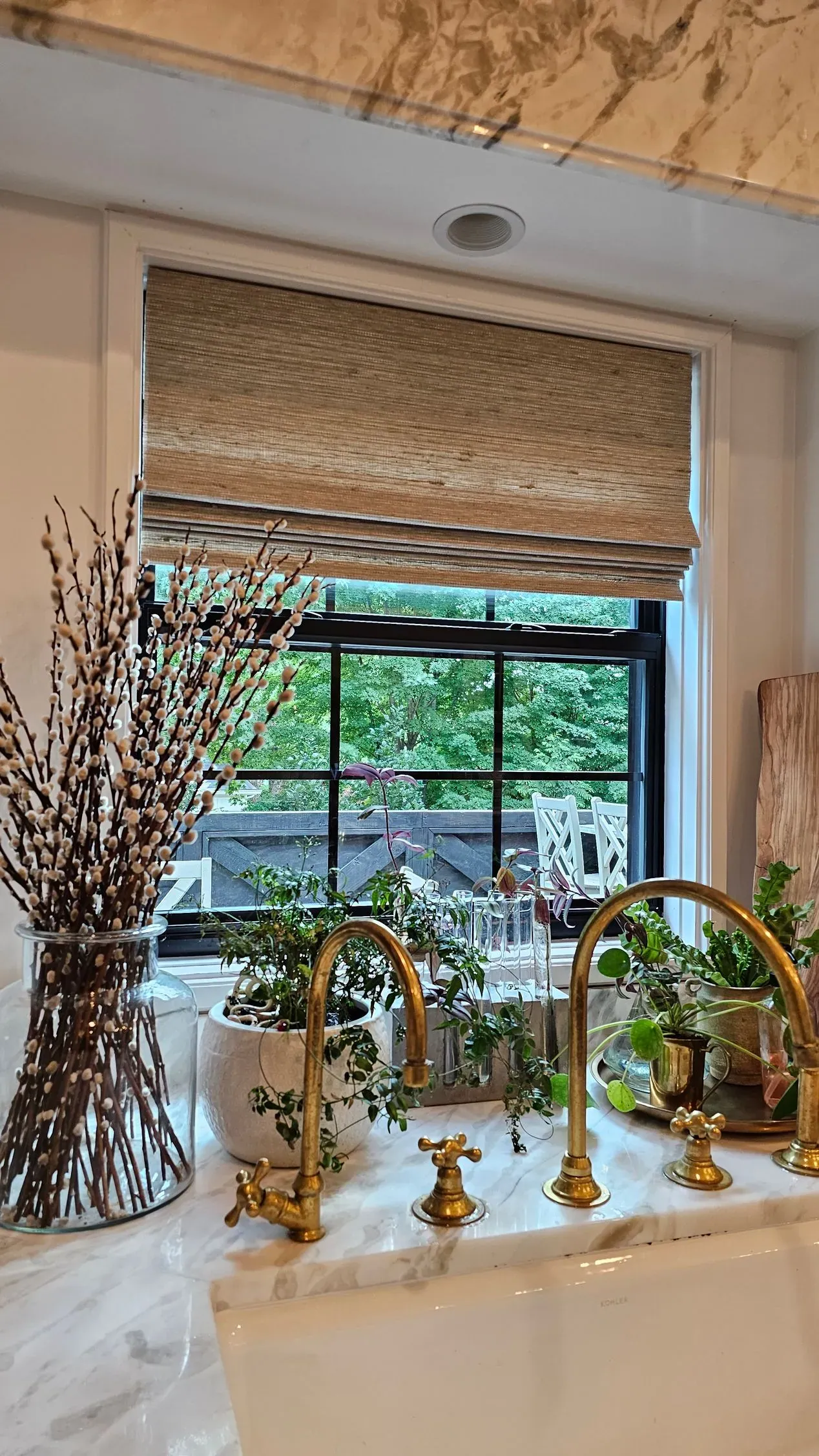 A Natural Woven Shade above a kitchen sink, installed by Solar Shield Blinds