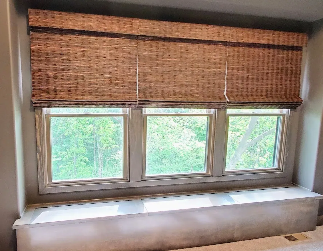 Natural Woven Shades on three windows, installed by Solar Shield Blinds