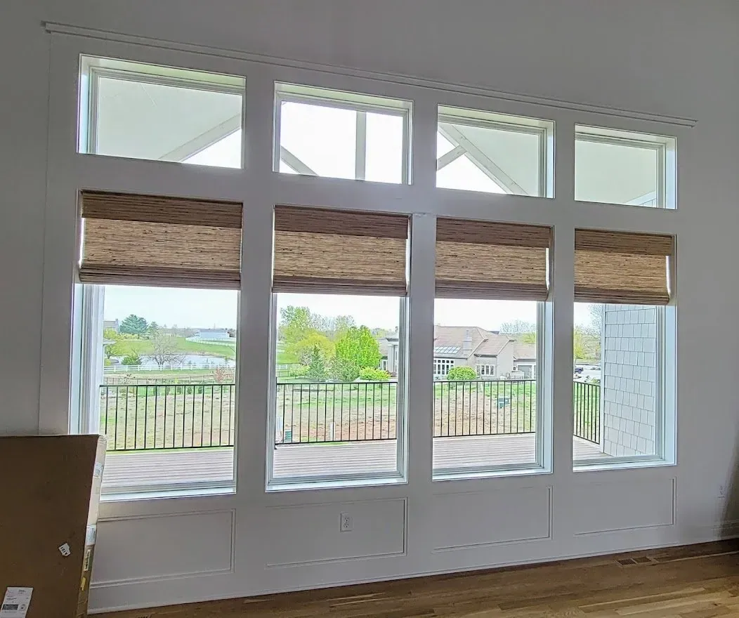 Natural Woven Shades in a living room, a Solar Shield Blinds install