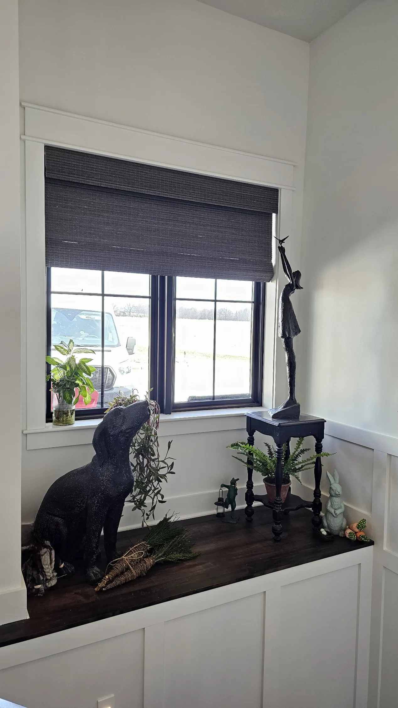 Natural Woven Shades over a window seat, measured and hung by Solar Shield Blinds