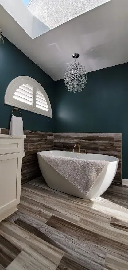 Plantation Shutters arched in a bathroom, installed by Solar Shield Blinds
