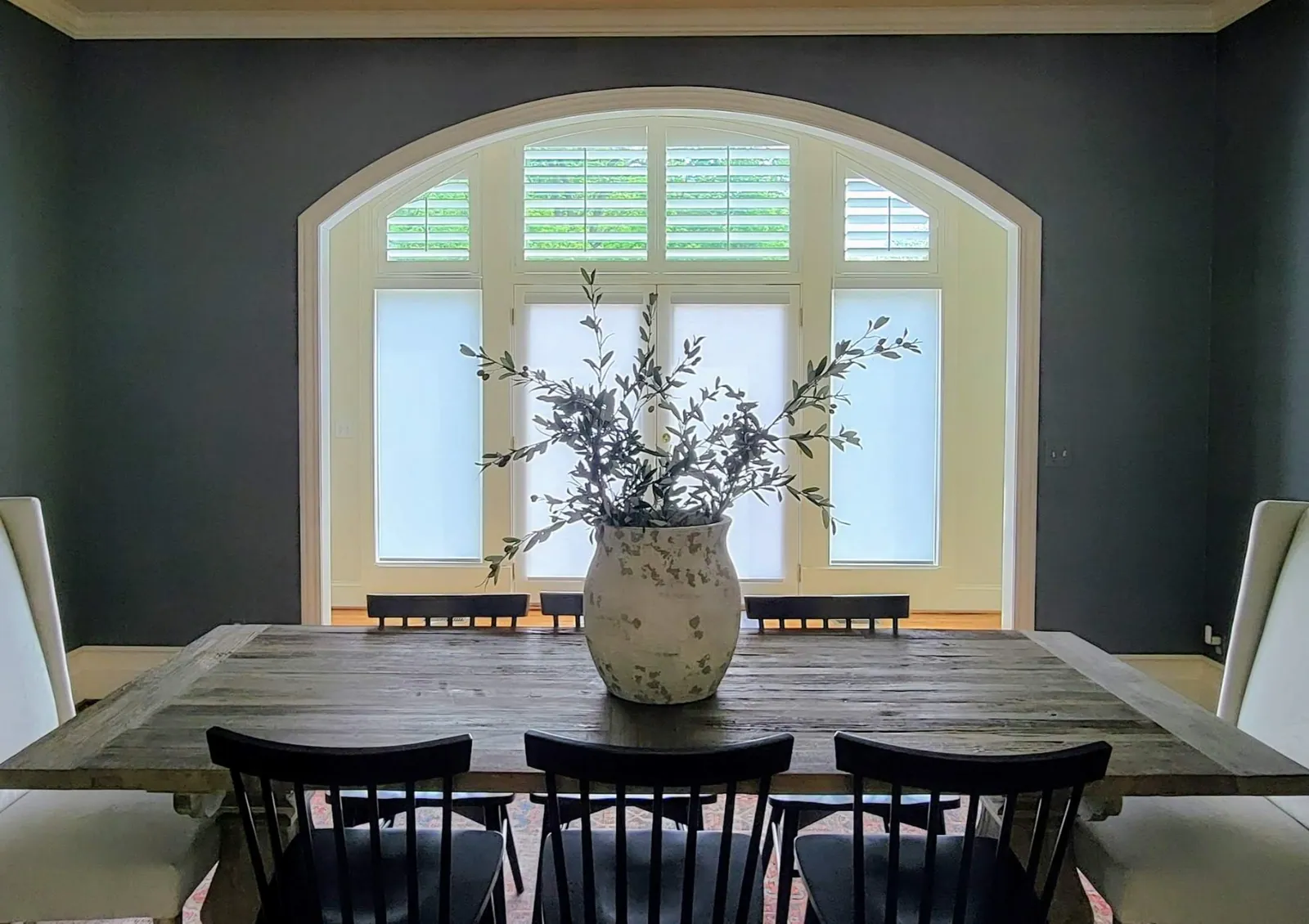 Arched plantation shutters in a dining room