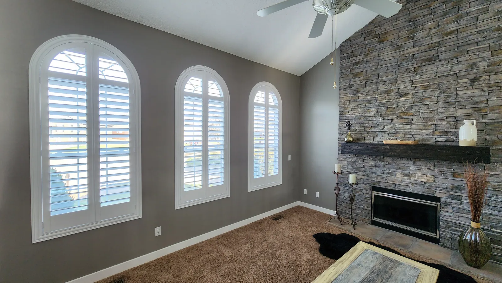 Plantation Shutters arched speciality in a living room, installed by Solar Shield Blinds
