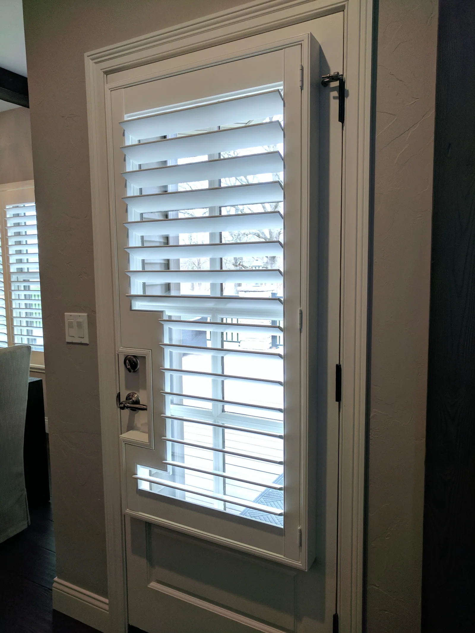 Custom plantation shutters french door cut out single door, installed by Solar Shield Blinds