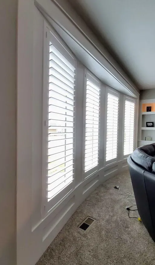 Plantation Shutters open in a living room, installed by Solar Shield Blinds