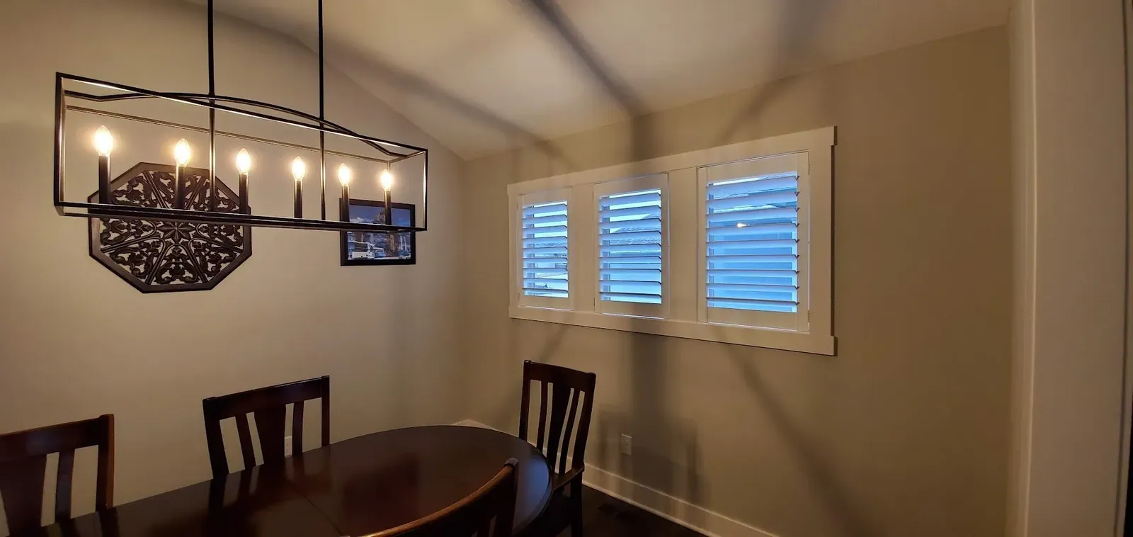 Plantation Shutters in a dining room, measured and hung by Solar Shield Blinds
