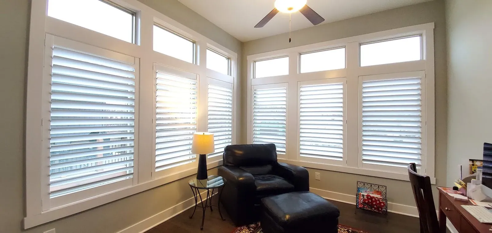 White plantation shutters on a wall of living room windows