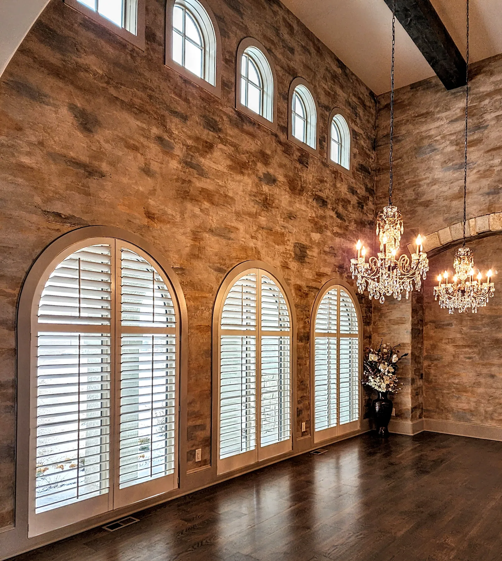 Speciality arched plantation shutters great room, installed by Solar Shield Blinds