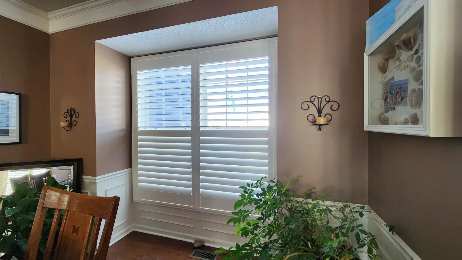 Plantation shutter in dining room, installed by Solar Shield Blinds