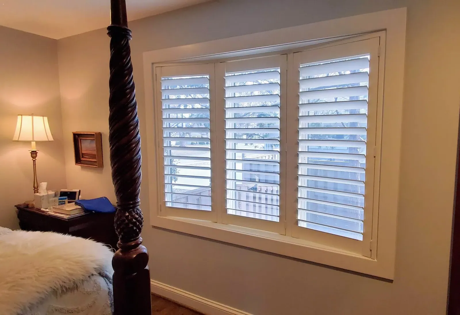 Plantation Shutters in a bedroom nook, a Solar Shield Blinds install